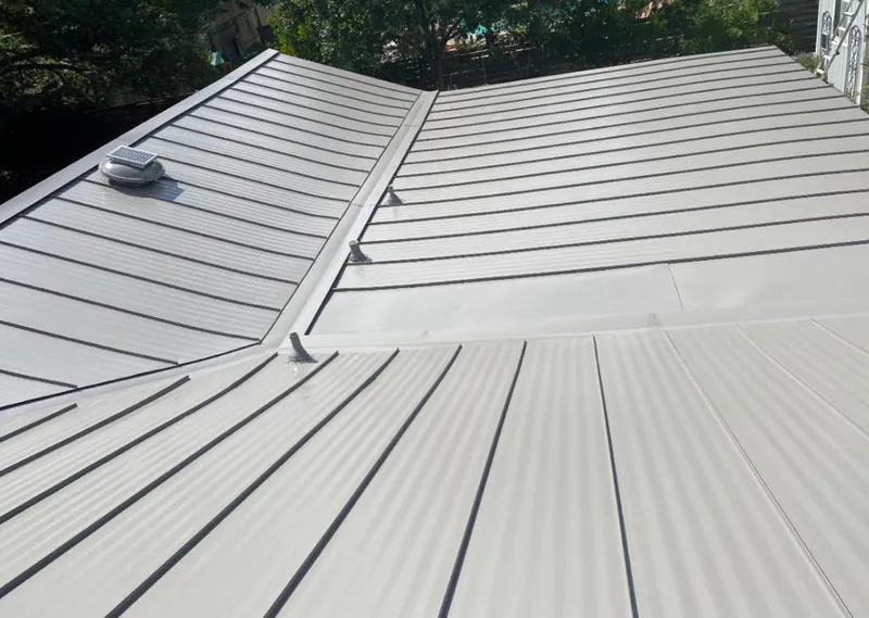 Solar attic fan installed on a metal roof for Roof Ventilation in Homestead Meadows North